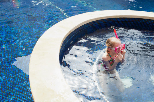 Girl snorkeling in swimming pool.