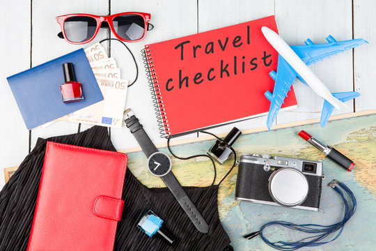 plane, map, passport, money, watch, camera, notepad with text "Travel checklist", sunglasses, wallet