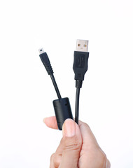 Hand holding USB to micro usb cable on white background