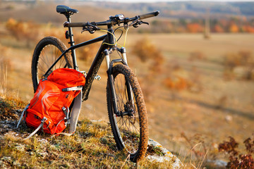 Fototapeta premium Mountain bike after ride in nature with backpack.