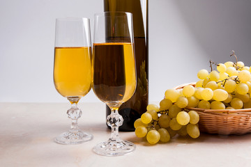 White wine and grapes. White wine in glasses, bottle of wine and
