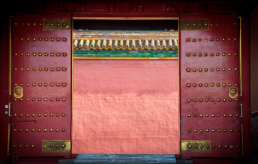 Ancient red wooden doors at the Forbidden City, Beijing