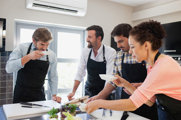 Chef tasting food in kitchen.