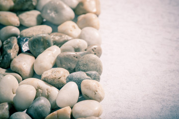 Stones on stone background, concept of harmony and tranquility. Decoration with stone pebbles as natural design backdrop with copy space.