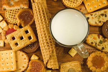 many delicious cookies and milk on the table close-up.