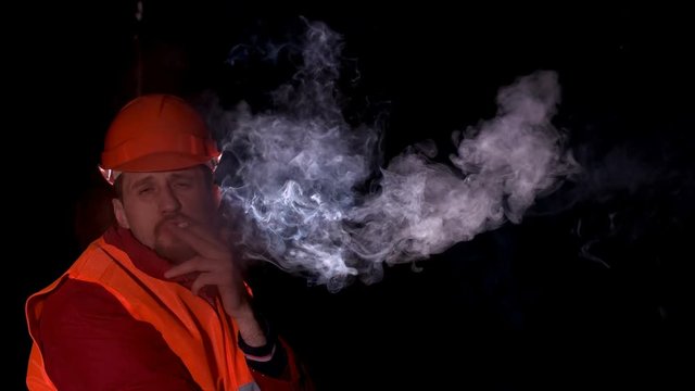 worker smoking a cigarette when resting