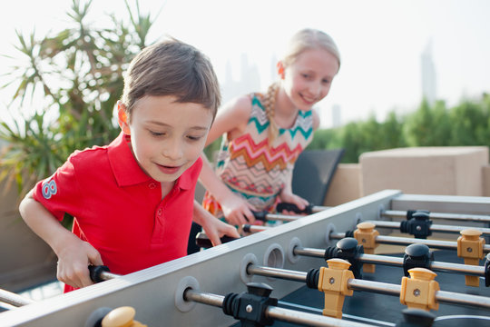 Children playing foosball.