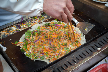 Chinese Jianbing pancake being prepared at a Shanghai street market