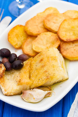 fried cod fish with potato on white dish