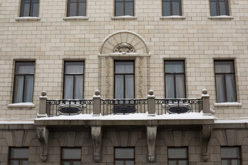 Balcony on the building of white brick