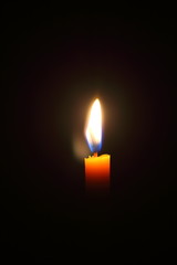 Lighting candles on a black background.