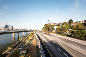 traffic on road near river in seoul at sunrise