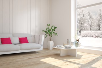 White room with sofa and winter landscape in window. Scandinavian interior design