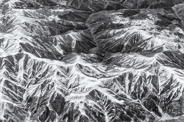 Complex of mountains seen from the air. Black and white version.