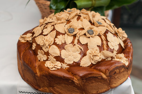 Closeup wedding loaf with poppy seeds and flowers on a table