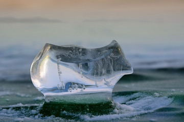 Piece fo ice in rays of sun