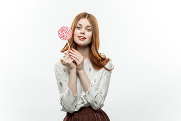 happy woman in a light shirt dark skirt, lollipop