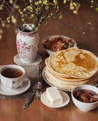 Morning vegetarian breakfast. Stack of delicious homemade pancakes or blini, cup