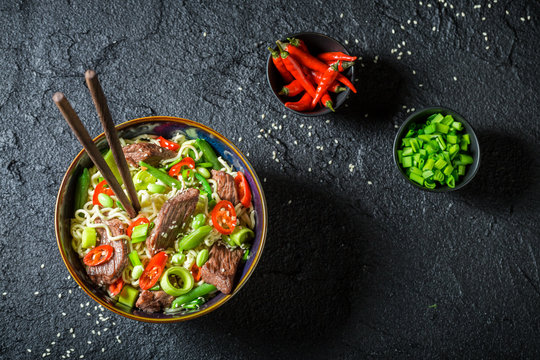 Spicy asian noodle with beef and vegetables