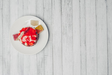 red cake with chocolate from hearts on saucer, jujube