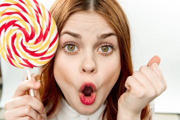 a woman with a round candy, an open mouth