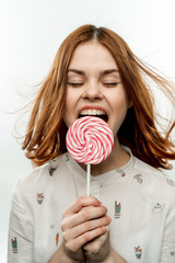 woman with open mouth and lollipop in front of face