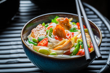 Hot noodle with vegetables, chicken and chili peppers