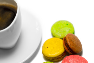 Coffee and colorful macaron on a white background. Isolated