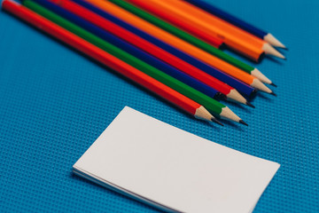 multicolored pencils and business cards