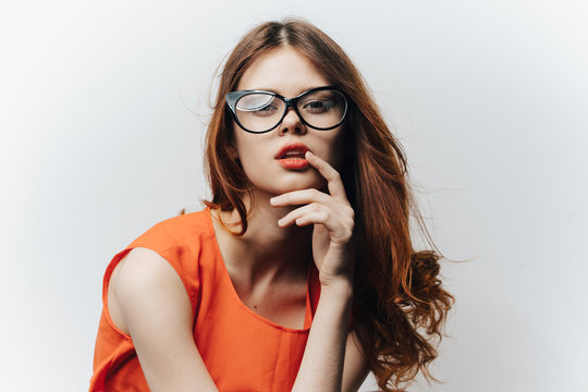 woman in orange dress and glasses on face