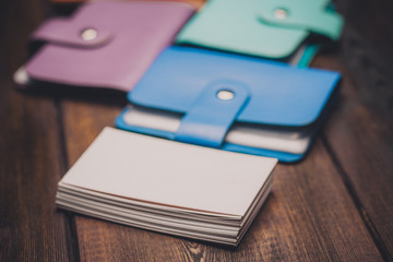 multicolored business cards and business cards on a wooden background