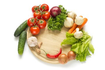 raw vegetables on a round wooden Board