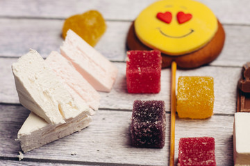 marshmallow, marmalade cubes, jelly, candy on a stick smiley