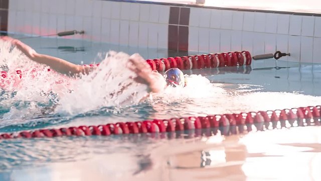 Female Swimmer Swims In Pool HD Slow-motion Video. Finish Butterfly Training Of Professional Athlete. Water Splashing.