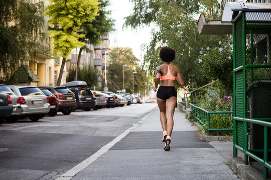 Rear shot of a female runner. Workout wellness concept.