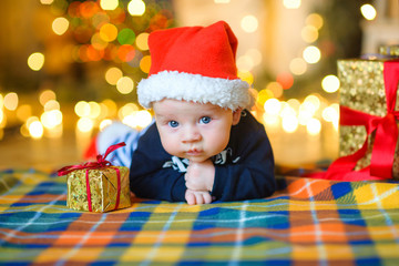 Baby to Santa Claus's cap