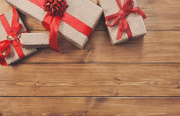 Presents in gift boxes on wood frame background