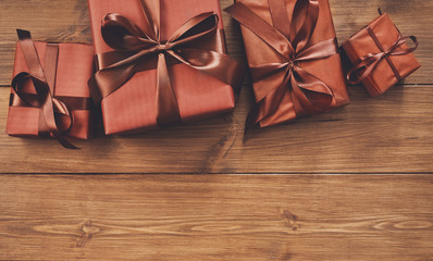 Presents in gift boxes on wood background with copy space
