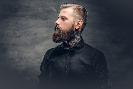 Bearded male with tattoo on his neck.