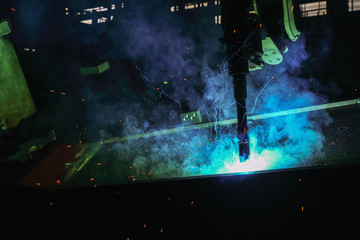 Sparks and smoke from robot welding  in manufacturing