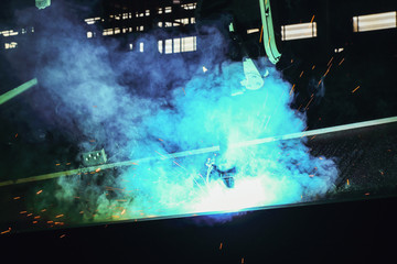 Sparks and smoke from robot welding  in manufacturing