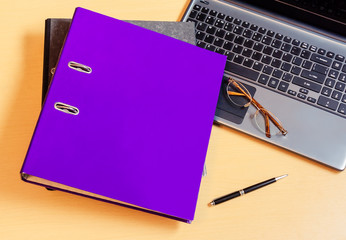 Folders with laptop computer on desk