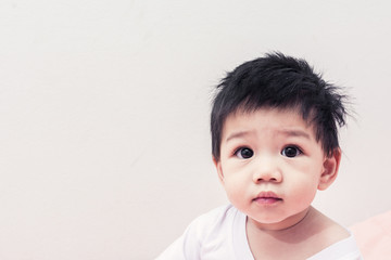 Asian boy on bed in White shirt  and Children healthy.