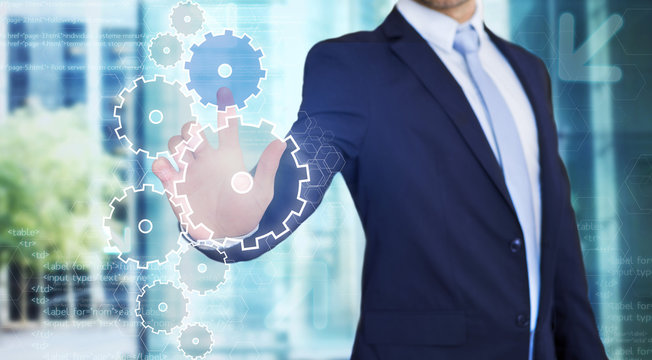 Businessman touching technology interface with gear wheel settin