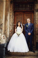 Elegant couple at the door of the building