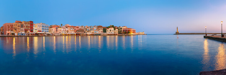 Obraz premium Picturesque panoramic view of old harbour with Lighthouse of Chania at sunrise, Crete, Greece