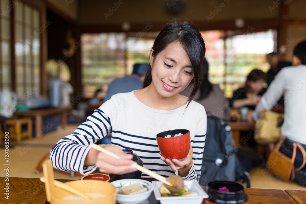 Sticker Woman eating rice in japanese restaurant