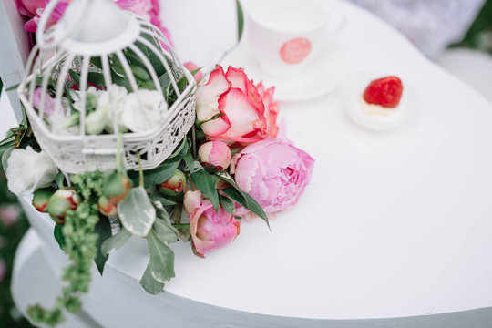beautiful pink peonies and roses lying on a white table
