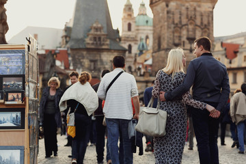 young woman and man walking on the old street together