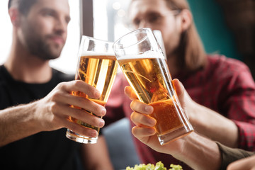 Young friends sitting in cafe while drinking alcohol.